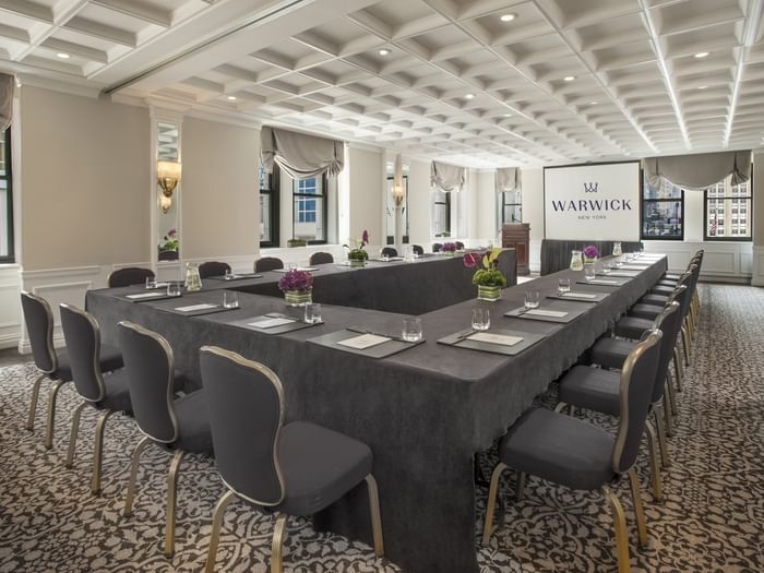 U-shaped table setup facing the screen near window with white coffered ceiling in Kent at Warwick New York