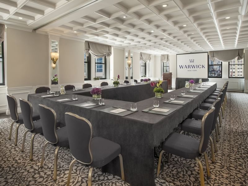 U-shaped table setup facing the screen near window with white coffered ceiling in Kent at Warwick New York