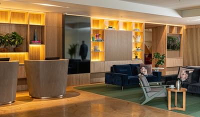 Modern lobby with a plush sofa, reception desk, and stylish shelving at Habitel Prime Hotel, a hotel business, Bogota
