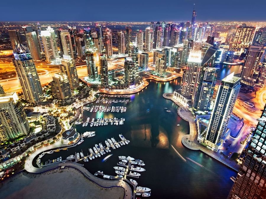 Twilight view of a marina with skyscrapers near DAMAC Maison Aykon City, the best luxury hotel in Dubai
