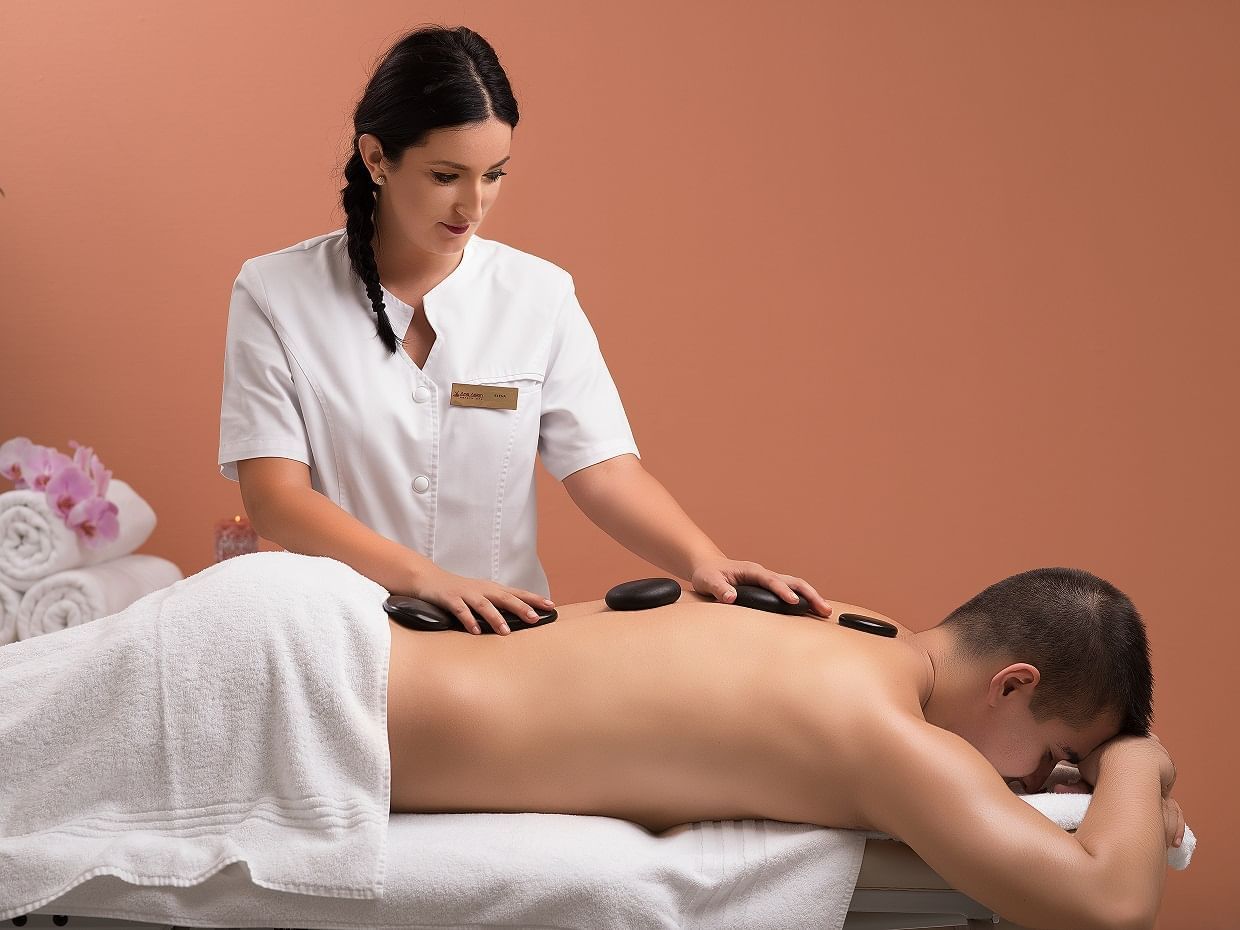 A man having a Hot Stones Massage Treatment in the Spa at Ana Hotels Europa