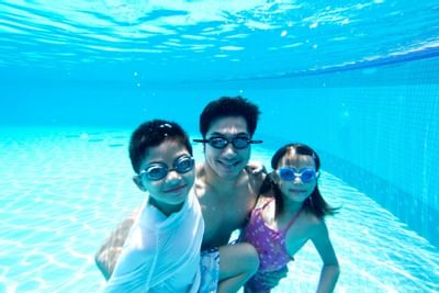 A family enjoying under the pool at Thistle Port Dickson Resort
