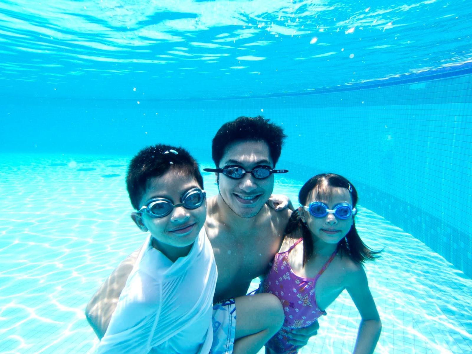 A family enjoying under the pool
