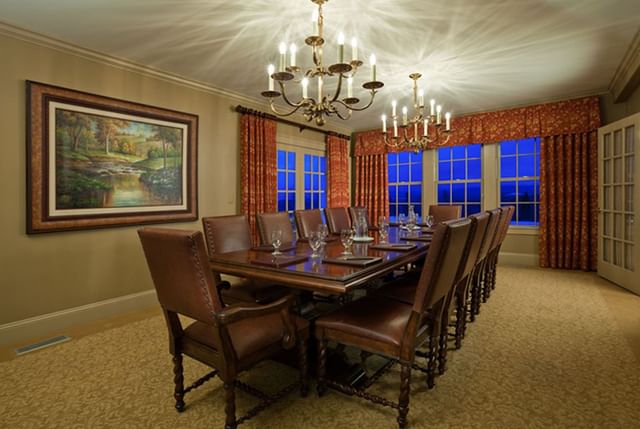 Leather chairs by a long table under chandeliers with windows in Eisenhower Boardroom at Mountain View Grand Resort & Spa