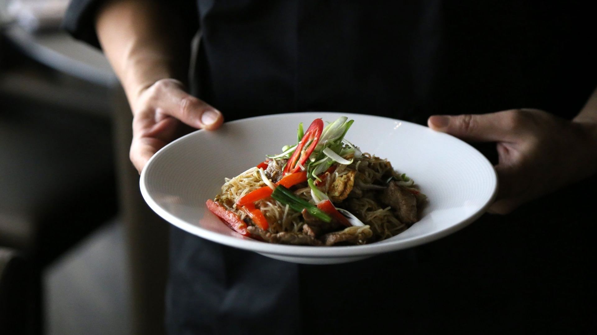 Close-up of a Chef serving a Tong tai dish at Warwick Le Crystal