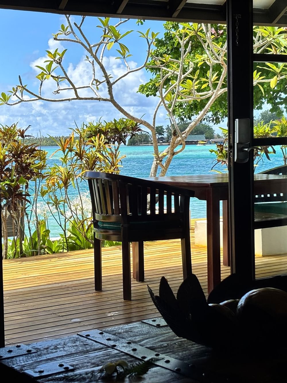 Wooden patio with sea view and outdoor furniture in a Pacific Pool Villa at Warwick Le Lagon, Efate.