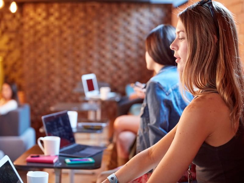 People working on laptops in a cozy cafe near Fiesta Americana