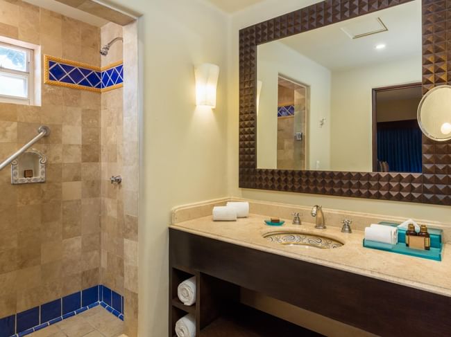 Bathroom with a wide vanity large framed mirror and walk-in shower in One Bedroom Villa at Hacienda Del Mar Los Cabos.