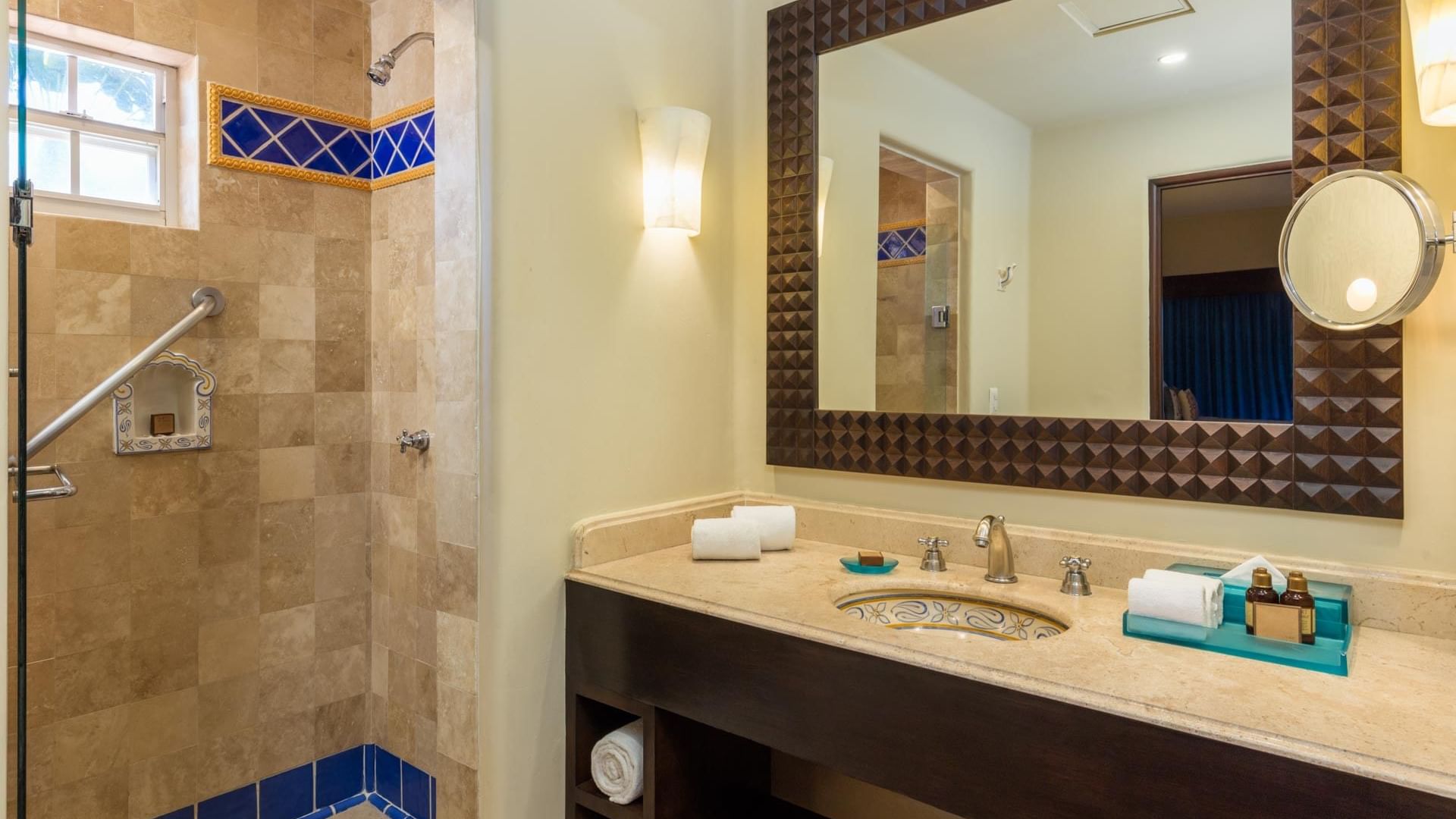 Bathroom with a wide vanity large framed mirror and walk-in shower in One Bedroom Villa at Hacienda Del Mar Los Cabos.