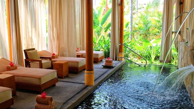 Spa chairs in front of a pond at FA Puerto Vallarta