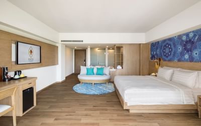 Comfy bed, working desk & sofa in Executive Room at Eastin Ashta Resort Canggu