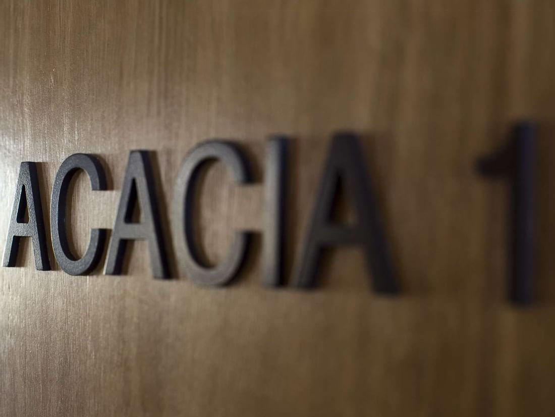 Close-up of ACACIA 1 Accessible Meetings room sign on a wooden door at The Sebel Mandurah