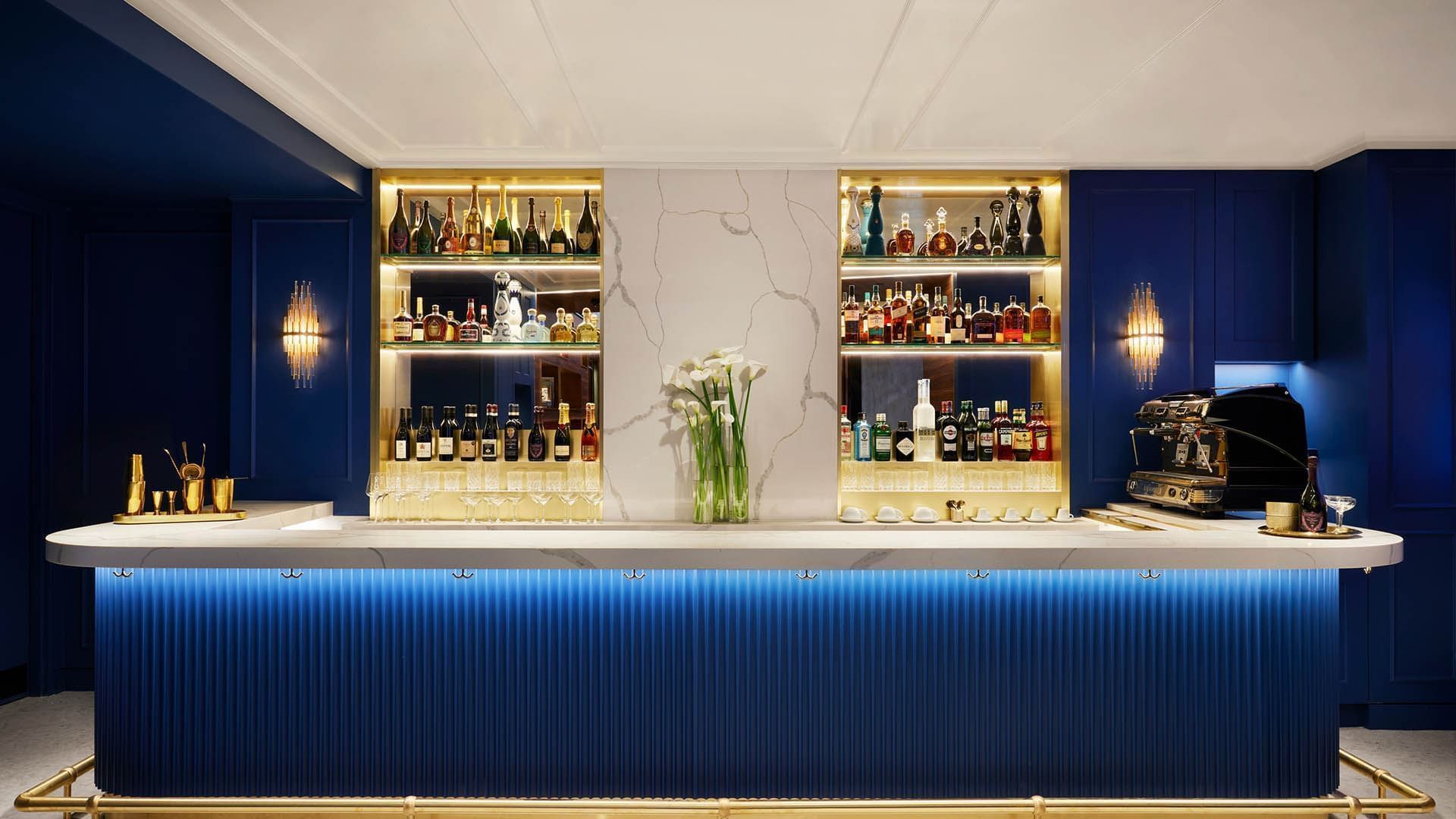 Coffee and cocktails bar with blue walls and gold accents at Gansevoort Meatpacking NYC