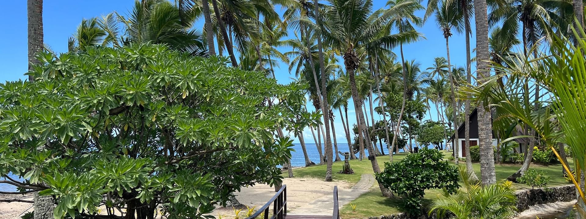 Wooden bridge leading to private beach at Tambua Sands Beach Resort in Sigatoka