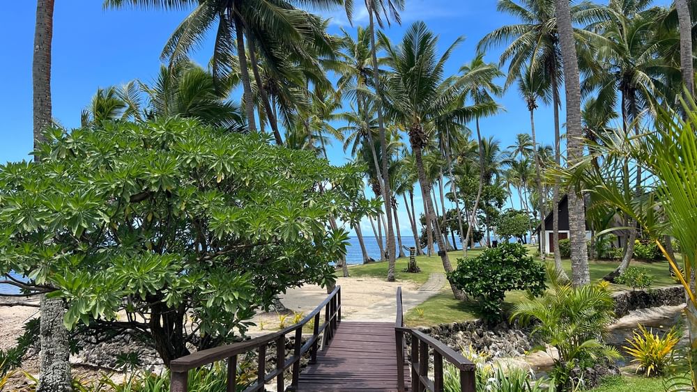 Wooden bridge leading to private beach at Tambua Sands Beach Resort in Sigatoka.