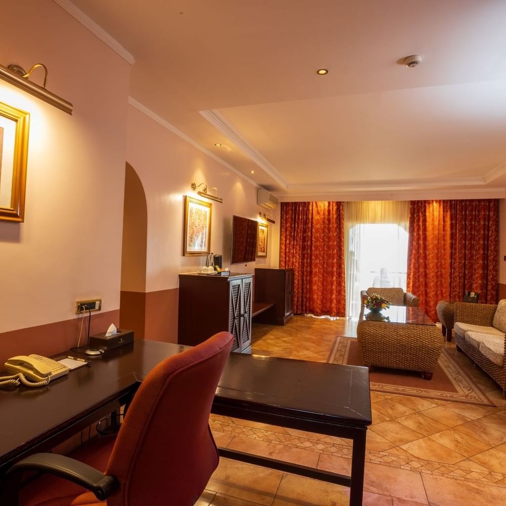 Elegant Executive Suite interior with desk and seating area at Lake Victoria Serena Golf Resort & Spa in Kampala.