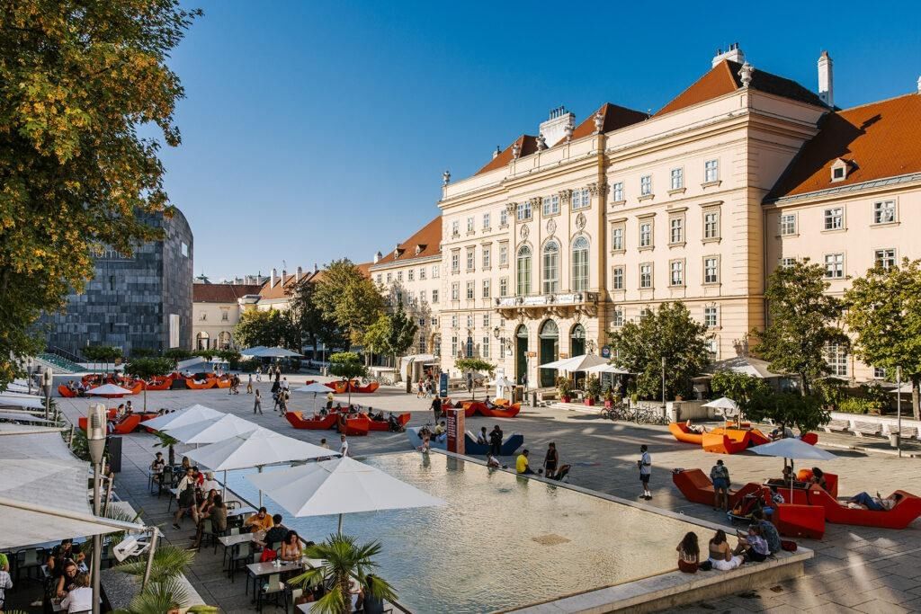 MuseumsQuartier Wien bei Tag mit mumok, Wasserbecken und entspanntem Stadtleben im Innenhof