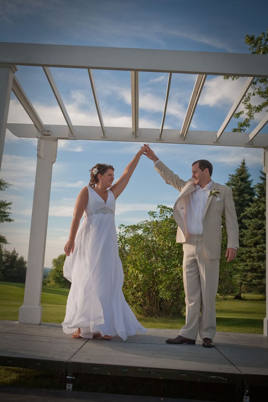 Wedding couple posing on the stage at Evergreen Resort