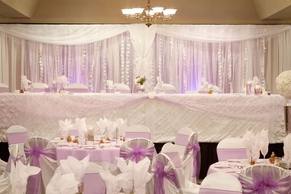 Tables and purple decorations at wedding reception venue