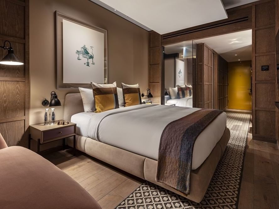 King bed & side table in Deluxe King Room at The Londoner Hotel