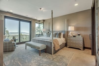 Bedroom with a king bed featuring large windows & interior at Stein Eriksen Residences