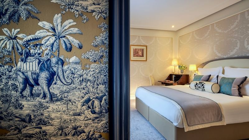 Deluxe Room with soft lighting and wall featuring tropical foliage at Hôtel Westminster - Paris
