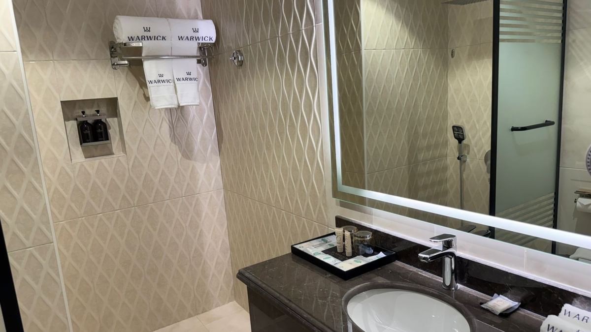 Superior Room bathroom featuring a vanity with a mirror and a towel rack at Warwick Jeddah Hotel & Spa