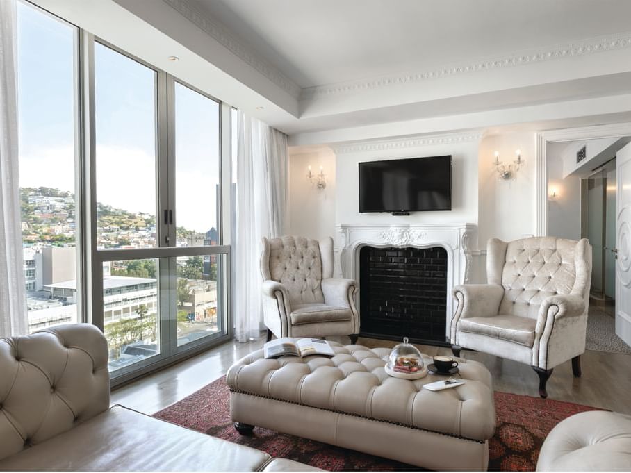 Premier Two Bedroom Suite at the Pepperclub Hotel with a fireplace, a seating area, and a large window with a scenic view