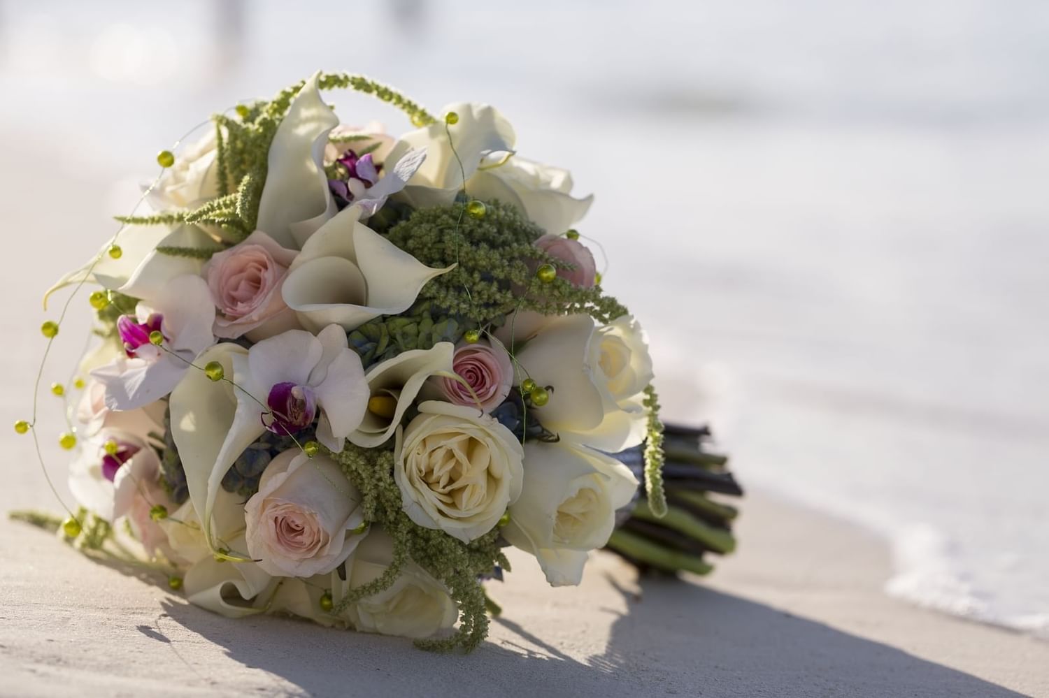 Close-up of a flower bouquet on the beach at Live Aqua Resorts