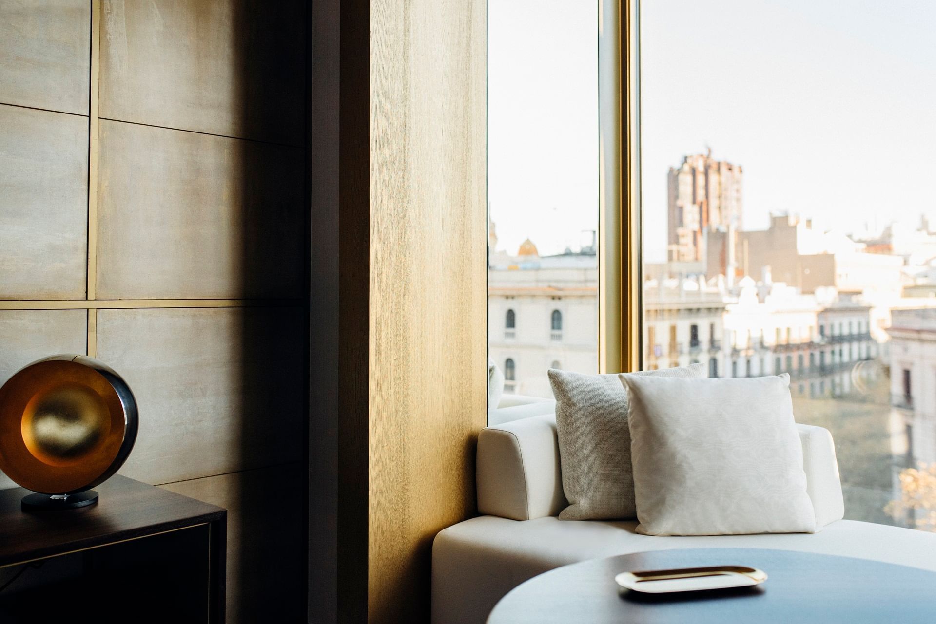Sofa next to the glass window at Almanac Hotels