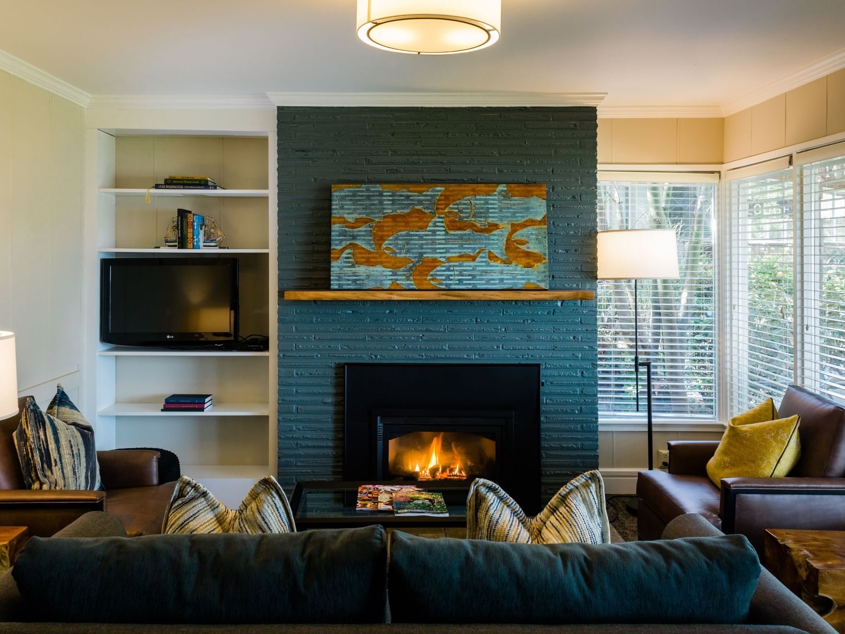A fireplace with cozy couches in the living room of Waterfront Deluxe Cottage at Alderbrook Resort & Spa