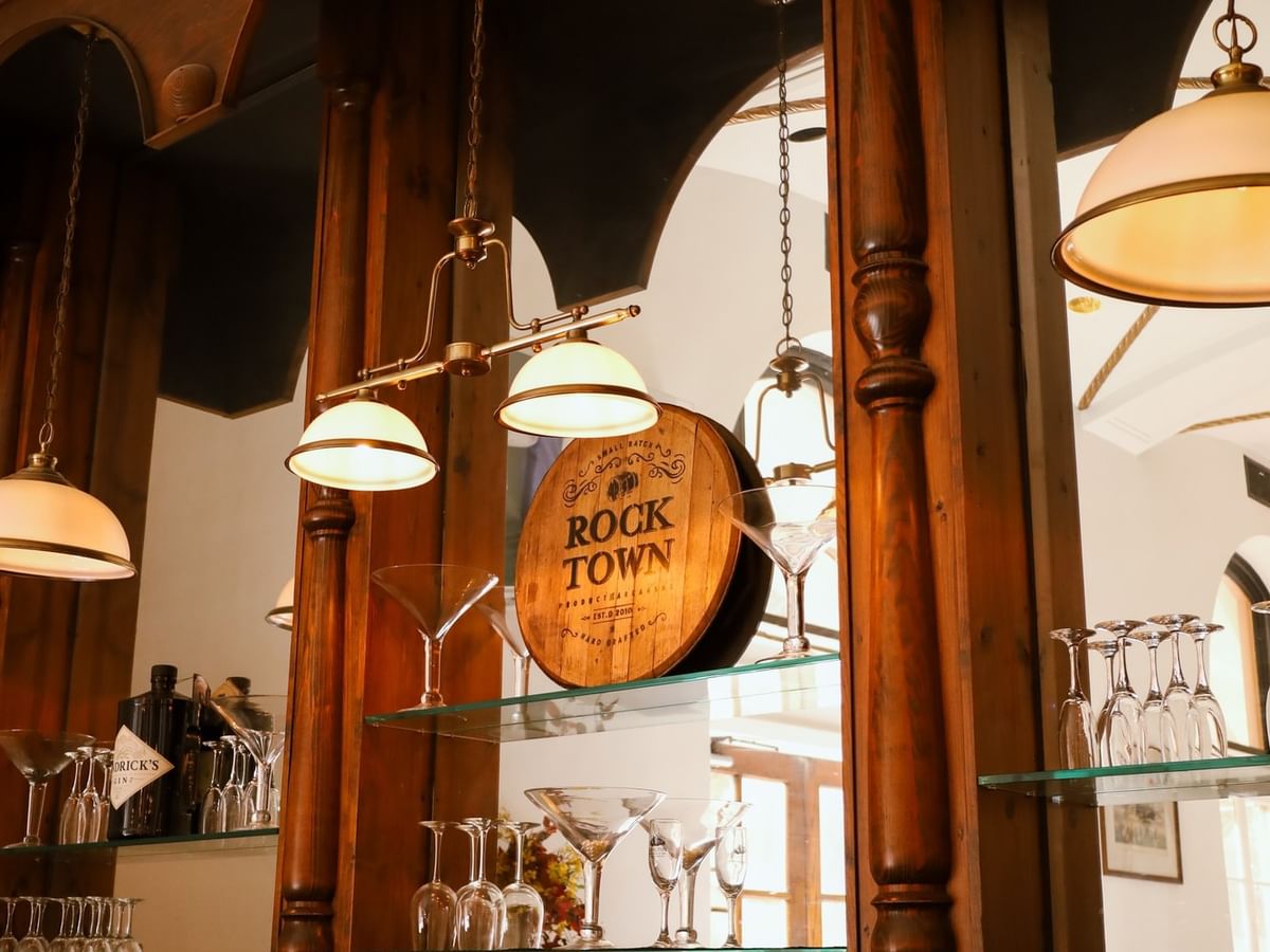Polished wooden bar featuring Rock Town whiskey and elegant glassware at Arlington Resort Hotel & Spa