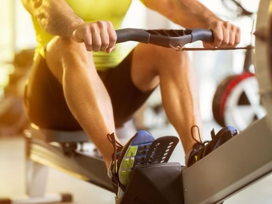 Lady using rowing machine in the gym at Royal Palms Hotel