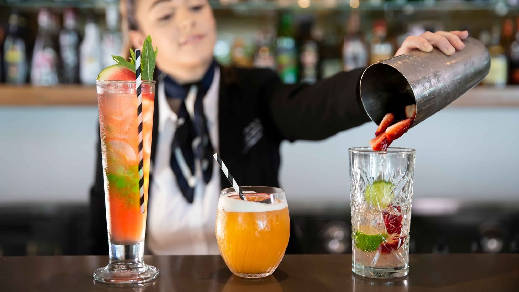 Female Bartender Mixing Cocktails at Pullman Magenta Shores 