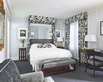 King bed & a work desk in Deluxe Guestroom at Eliot Hotel