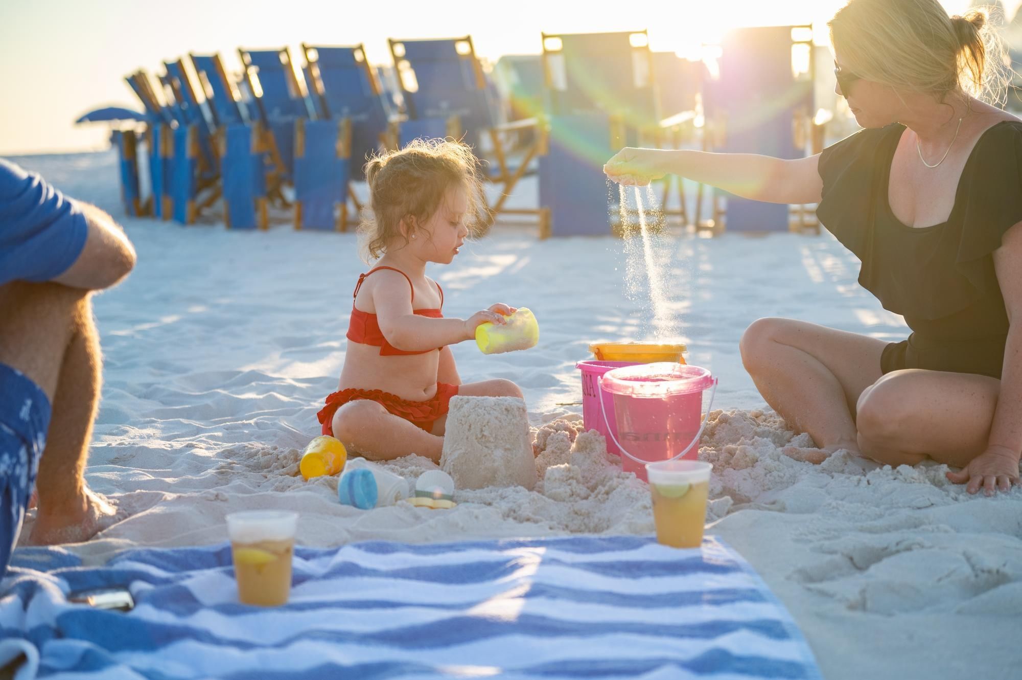 Family having fun building sand castles and playing at Camp Creek Inn