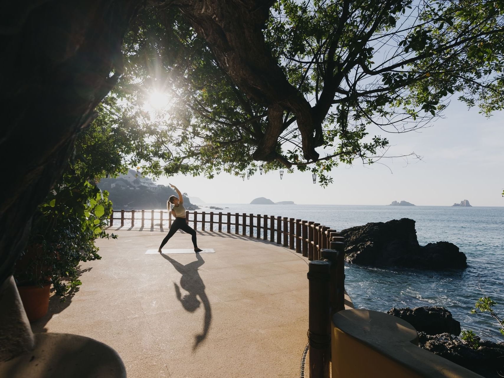 Woman doing yoga outdoors with a Sea view at Cala de Mar Resort