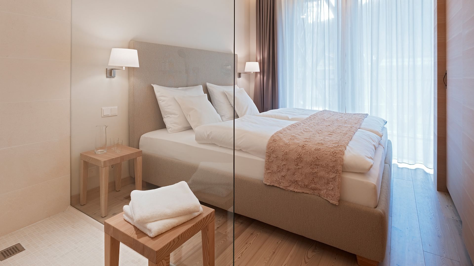 Large bed in Residence Comfort Room at Falkensteiner Hotels