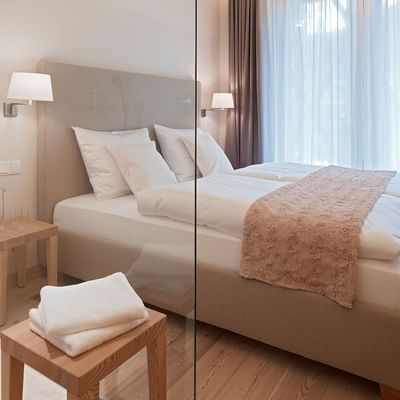 Large bed in Residence Comfort Room at Falkensteiner Hotels