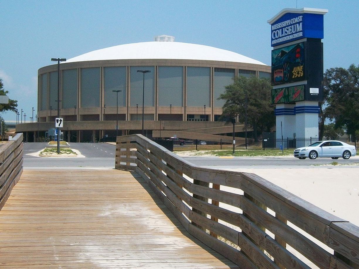 The Mississippi Coast Coliseum and Convention Center viewed from a wooden boardwalk near The Markham Hotel