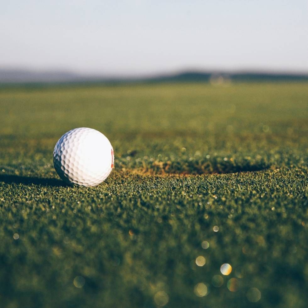 A golf ball by the hole near Falkensteiner Hotels