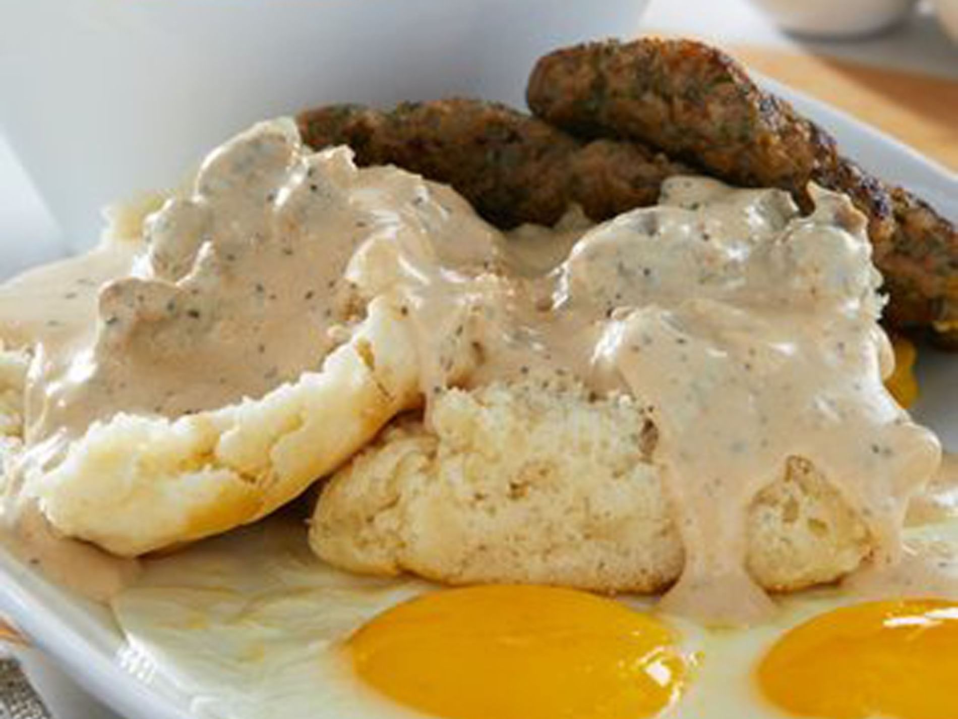 Close-up of a breakfast featuring eggs benedict & toast in Another Broken Egg near Ocean Lodge Boca Raton