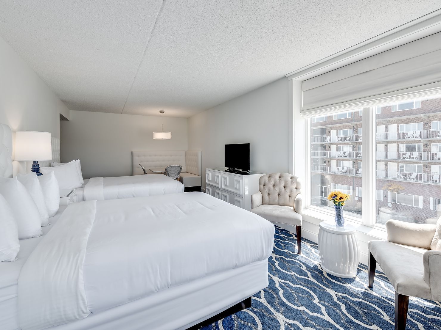 room with two all white beds