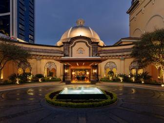 Grand dome entrance featuring a lit fountain and elegant stone architecture at night at Quinta Real Monterrey