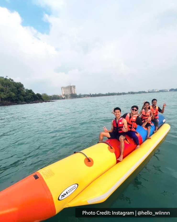 a group of friends posing on a banana boat