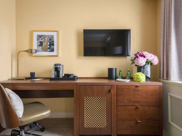 Work desk, chair & a wall TV in Queen Room at Warwick Allerton