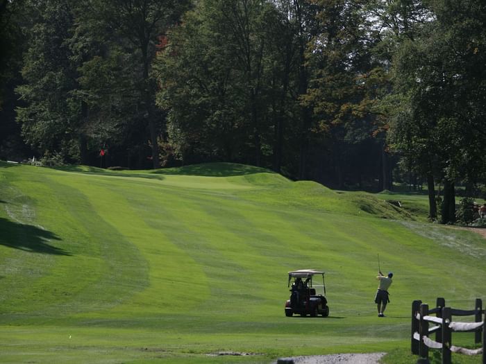 Golfer with cart at Whiteface Club & Resort.