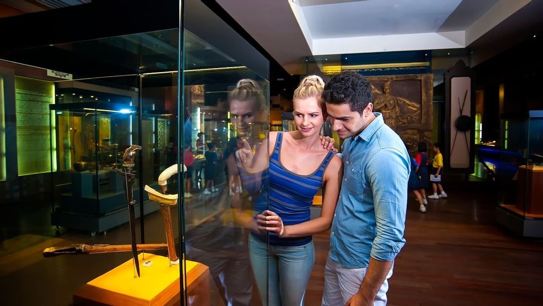 A couple gazing an artifact at Muzium Negara near Sunway Resort