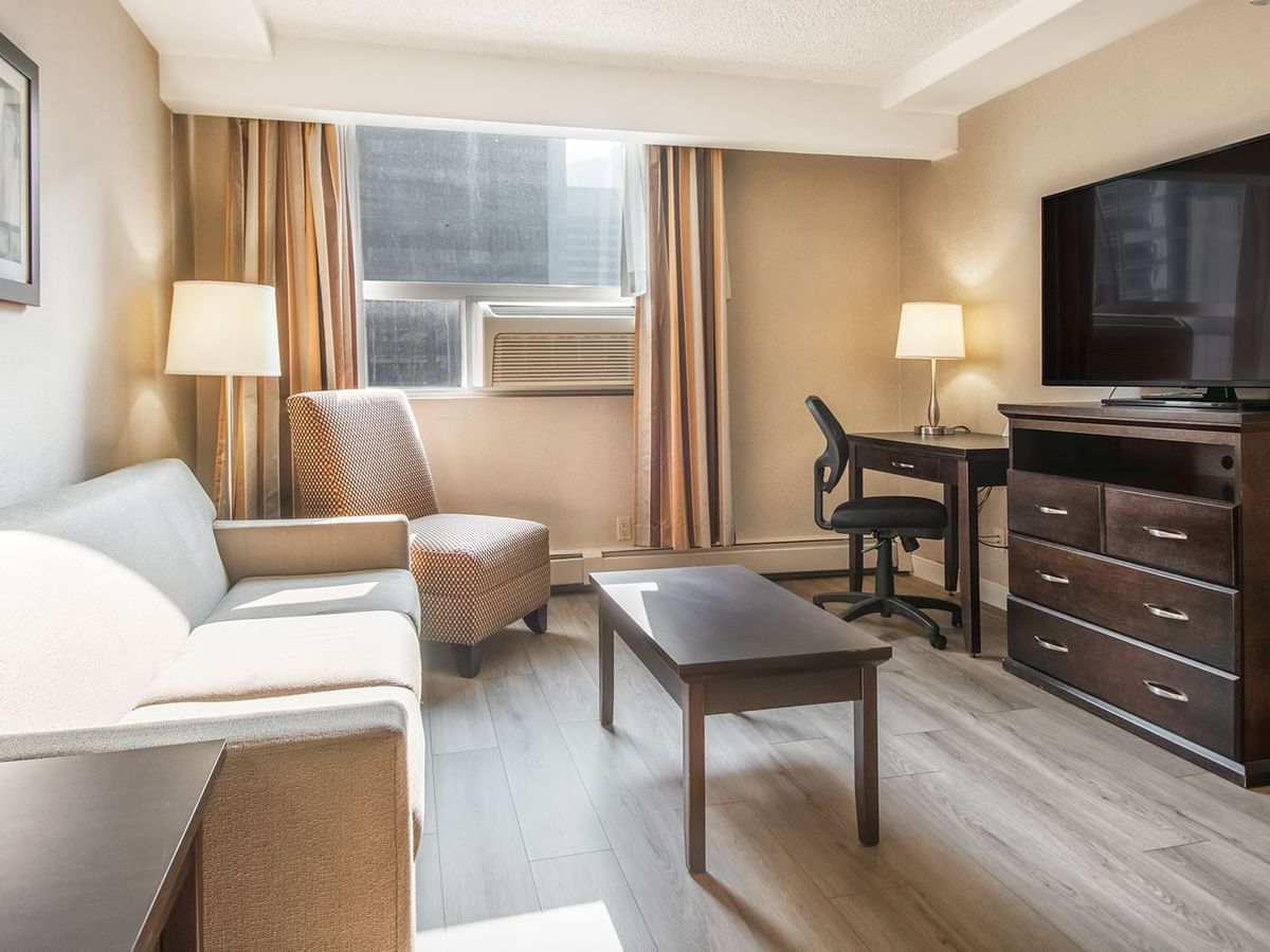 Hotel suite sofa, table, TV, work desk, and chair