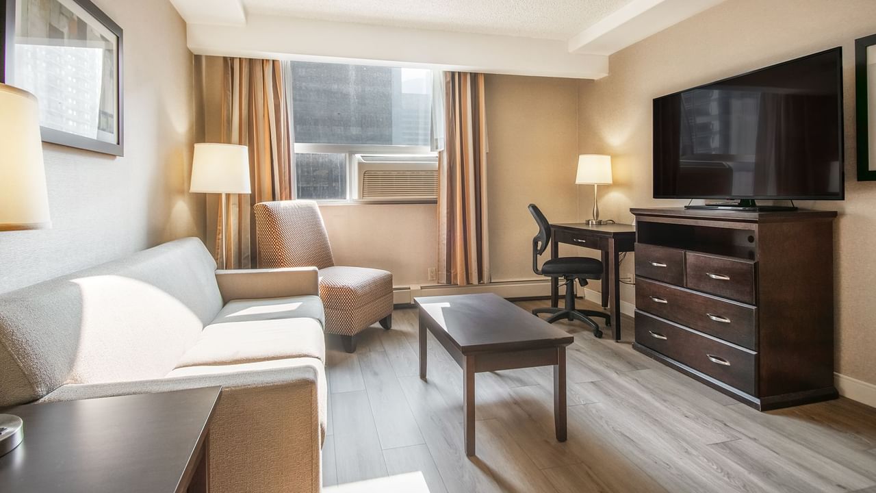 Hotel suite sofa, table, TV, work desk, and chair